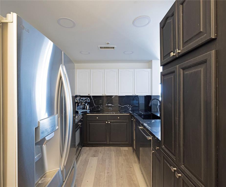 3475 Oak Valley Road Northeast, Unit 1450 Atlanta, GA 30326 - Photo 18 of 28 a kitchen with stainless steel appliances granite countertop a refrigerator and a sink