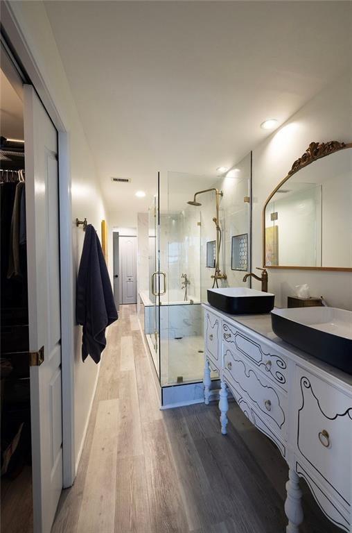 3475 Oak Valley Road Northeast, Unit 1450 Atlanta, GA 30326 - Photo 25 of 28 a large bathroom with a double vanity sink and a mirror