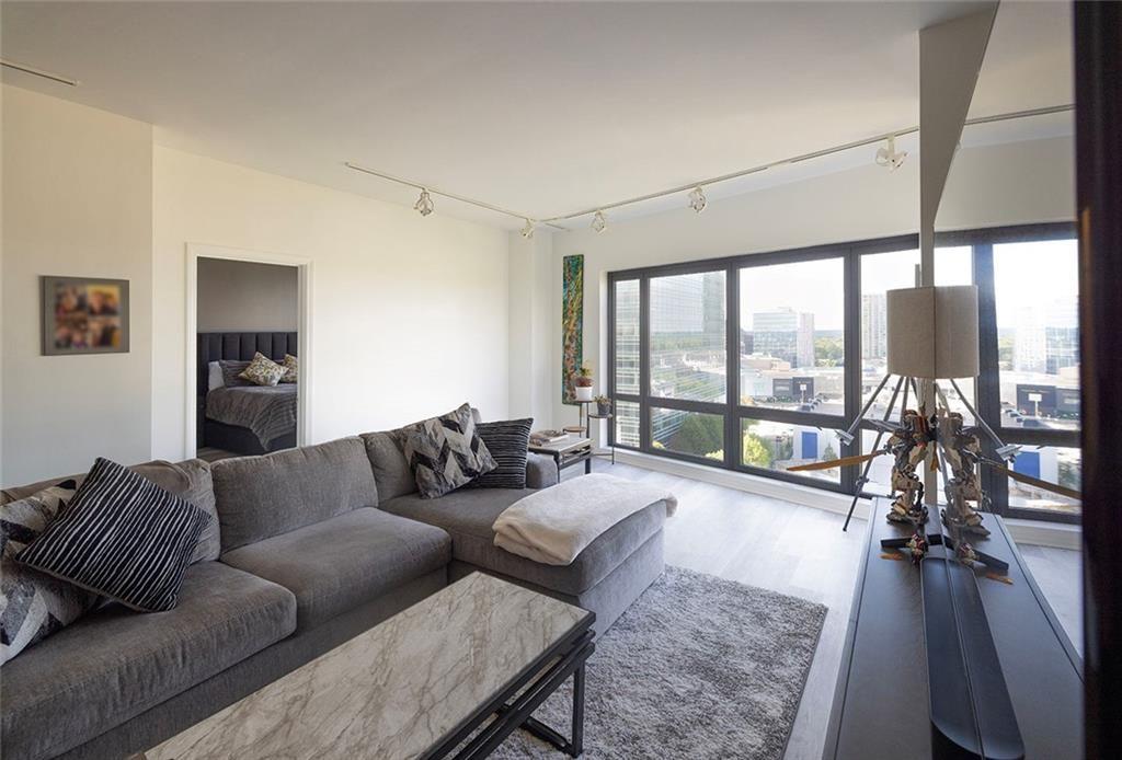 3475 Oak Valley Road Northeast, Unit 1450 Atlanta, GA 30326 - Photo 26 of 28 a living room with furniture and a large window