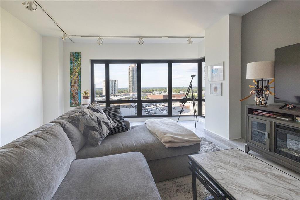 3475 Oak Valley Road Northeast, Unit 1450 Atlanta, GA 30326 - Photo 27 of 28 a living room with furniture and a floor to ceiling window