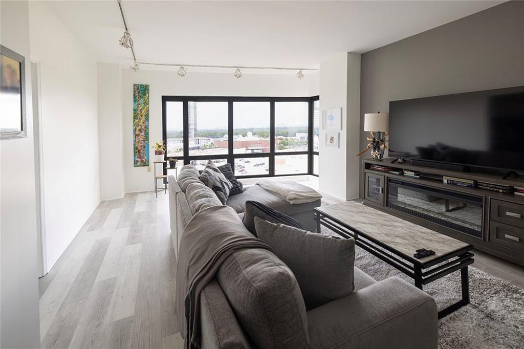 3475 Oak Valley Road Northeast, Unit 1450 Atlanta, GA 30326 - Photo 28 of 28 a living room with furniture and a flat screen tv
