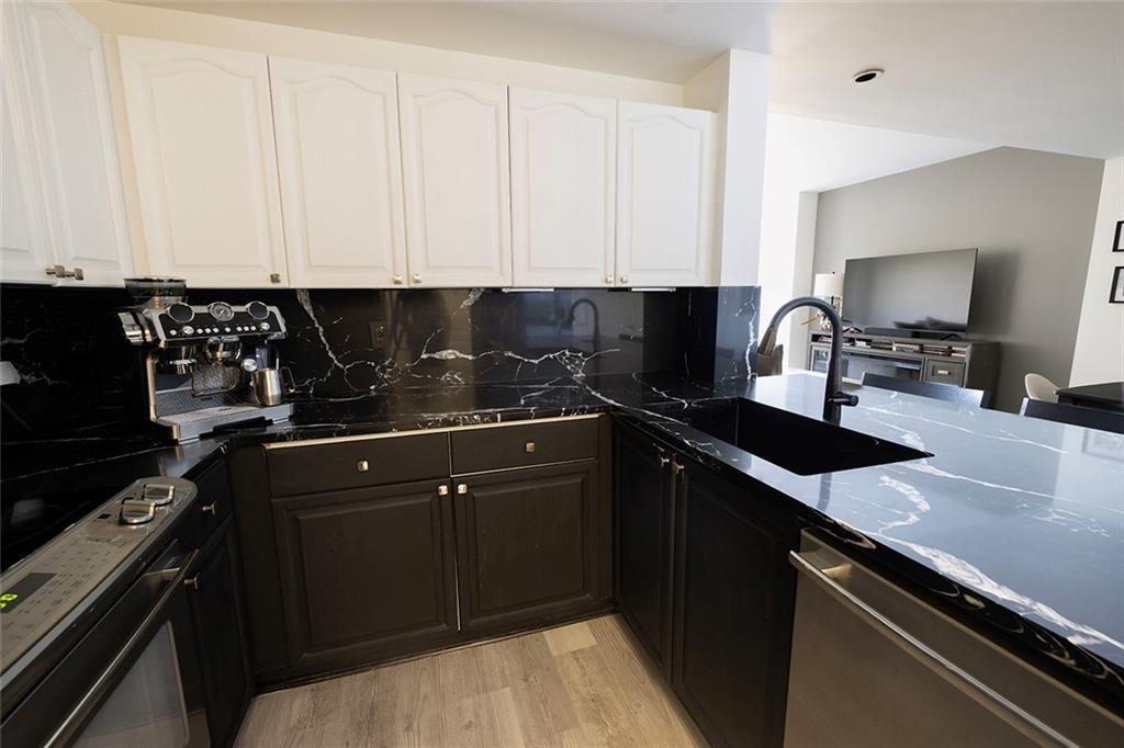 3475 Oak Valley Road Northeast, Unit 1450 Atlanta, GA 30326 - Photo 4 of 28 a kitchen with a sink and cabinets