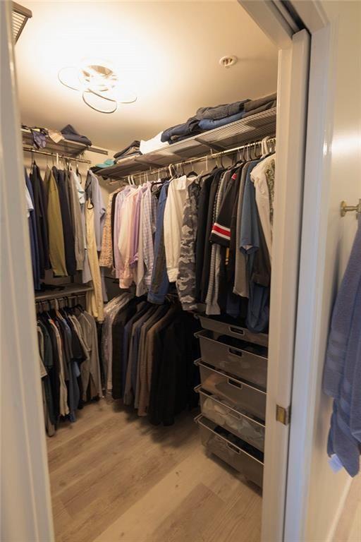 3475 Oak Valley Road Northeast, Unit 1450 Atlanta, GA 30326 - Photo 9 of 28 a view of walk in closet with clothes and shoes
