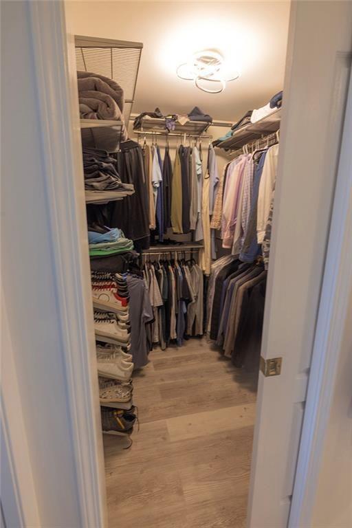 3475 Oak Valley Road Northeast, Unit 1450 Atlanta, GA 30326 - Photo 10 of 28 a view of walk in closet with clothes and shoes