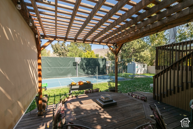 1764 West 1200th Street North Mapleton, UT 84664 - Photo 18 of 35 Expansive multi-level wood deck with a slatted pergola, overlooking a blue sport court