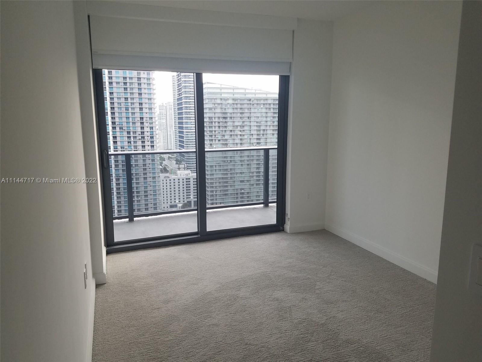 45 Southwest 9th Street, Unit 3103 Miami, FL 33130 - Photo 12 of 23 a view of an empty room with glass door