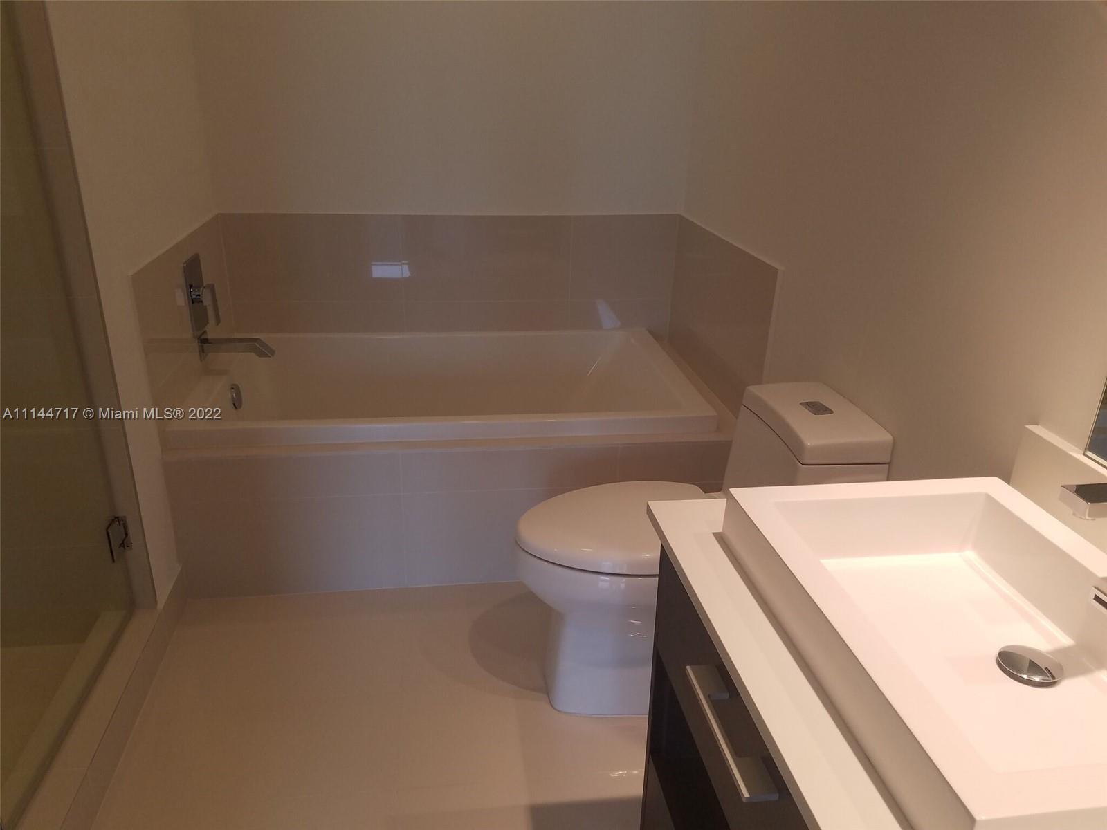 45 Southwest 9th Street, Unit 3103 Miami, FL 33130 - Photo 15 of 23 a bathroom with a sink and a toilet