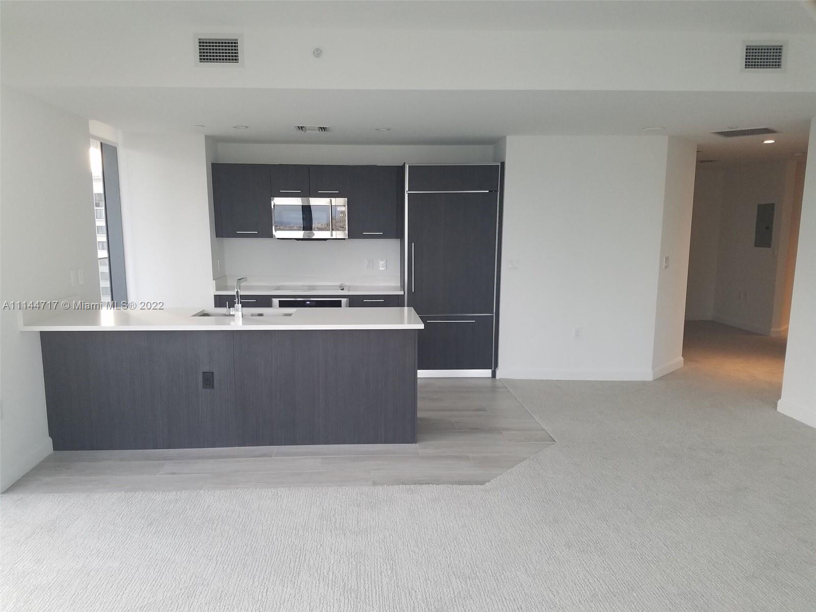 45 Southwest 9th Street, Unit 3103 Miami, FL 33130 - Photo 8 of 23 a living room with stainless steel appliances kitchen island a stove a refrigerator and a stove