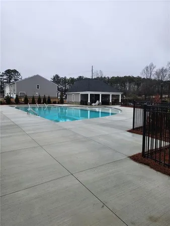 a view of swimming pool in front of residential houses