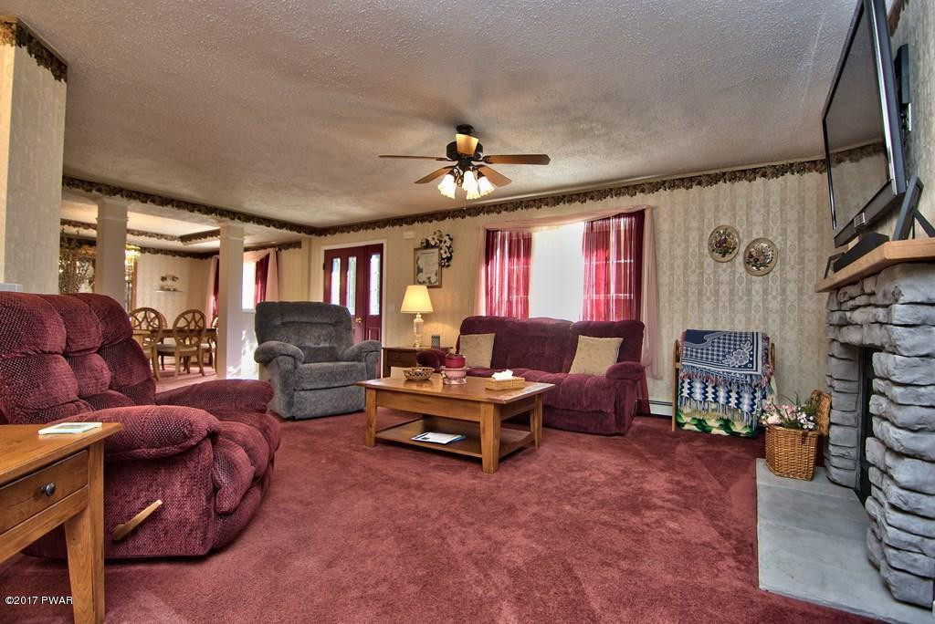 145 Keystone Road Lake Ariel, PA 18436 - Photo 11 of 52 a living room with furniture a fireplace and a large window