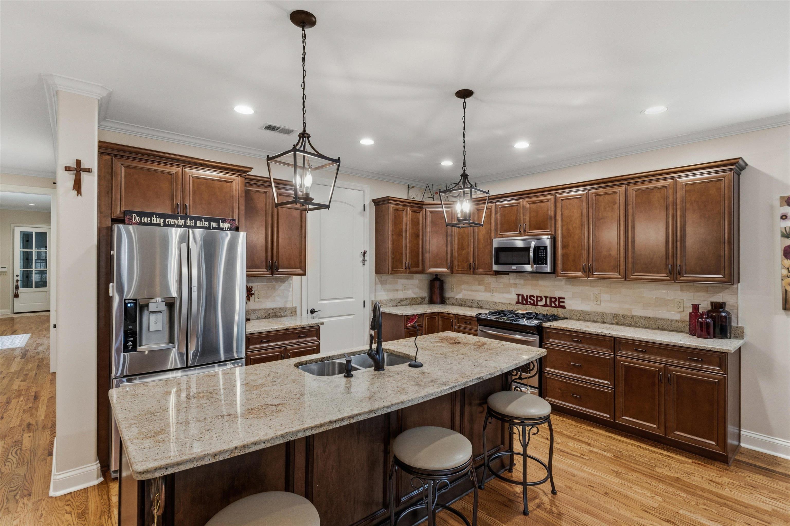 1011 Ostlers Way Collierville, TN 38017 - Photo 11 of 31 a kitchen with kitchen island granite countertop a sink a counter space appliances and cabinets