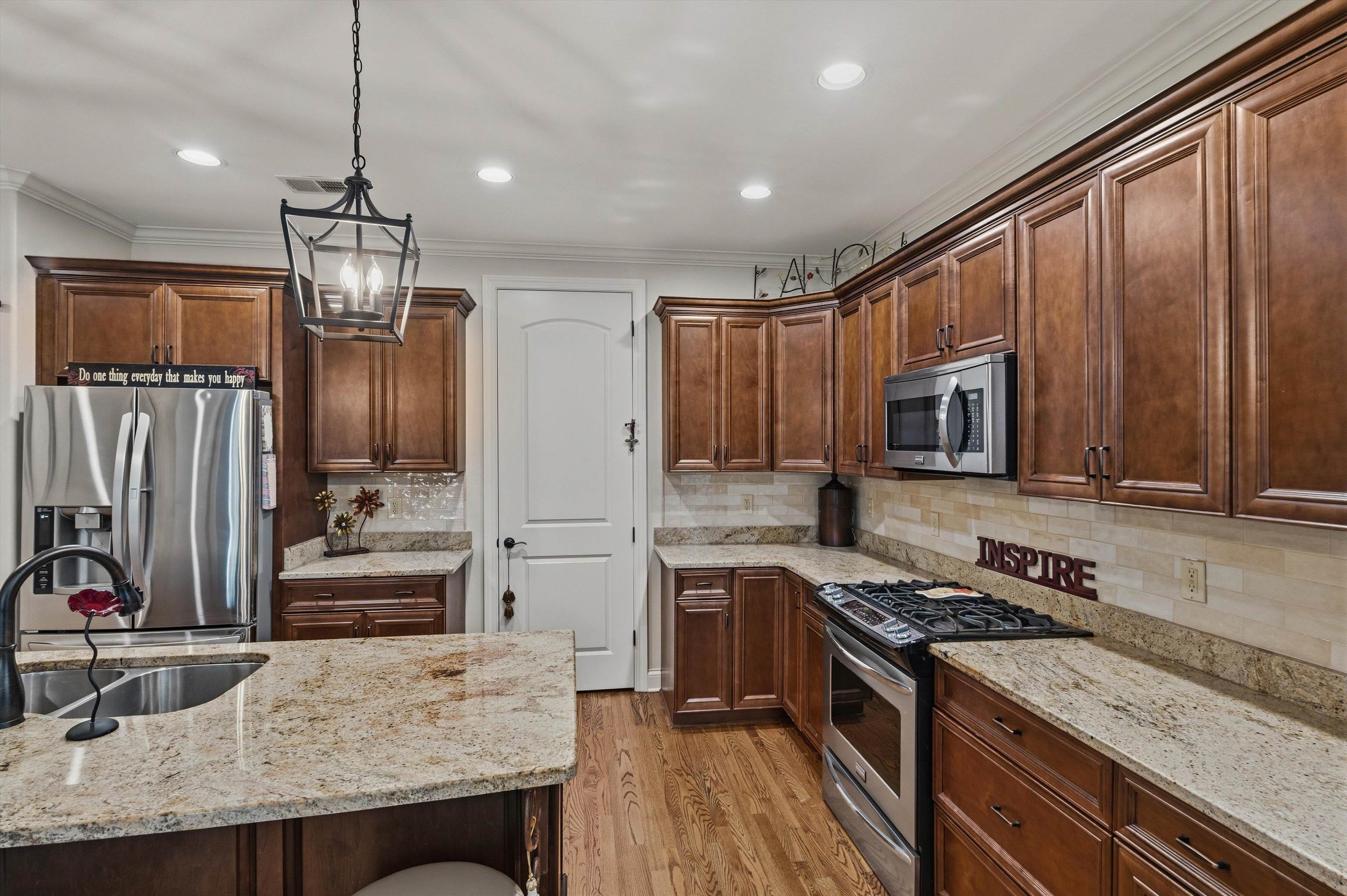 1011 Ostlers Way Collierville, TN 38017 - Photo 12 of 31 a kitchen with stainless steel appliances granite countertop a stove refrigerator and cabinets