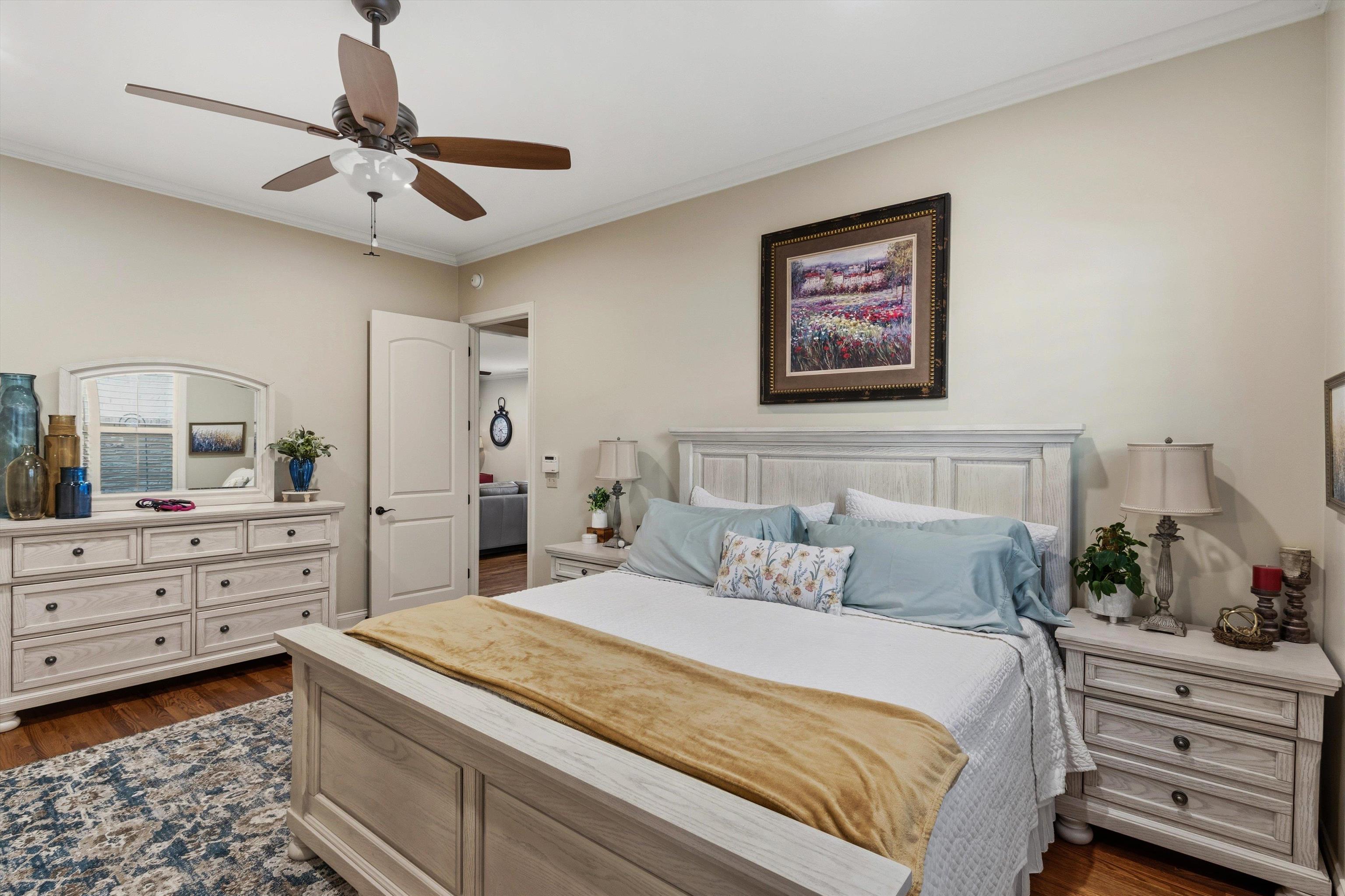 1011 Ostlers Way Collierville, TN 38017 - Photo 14 of 31 a bedroom with a bed and a chandelier