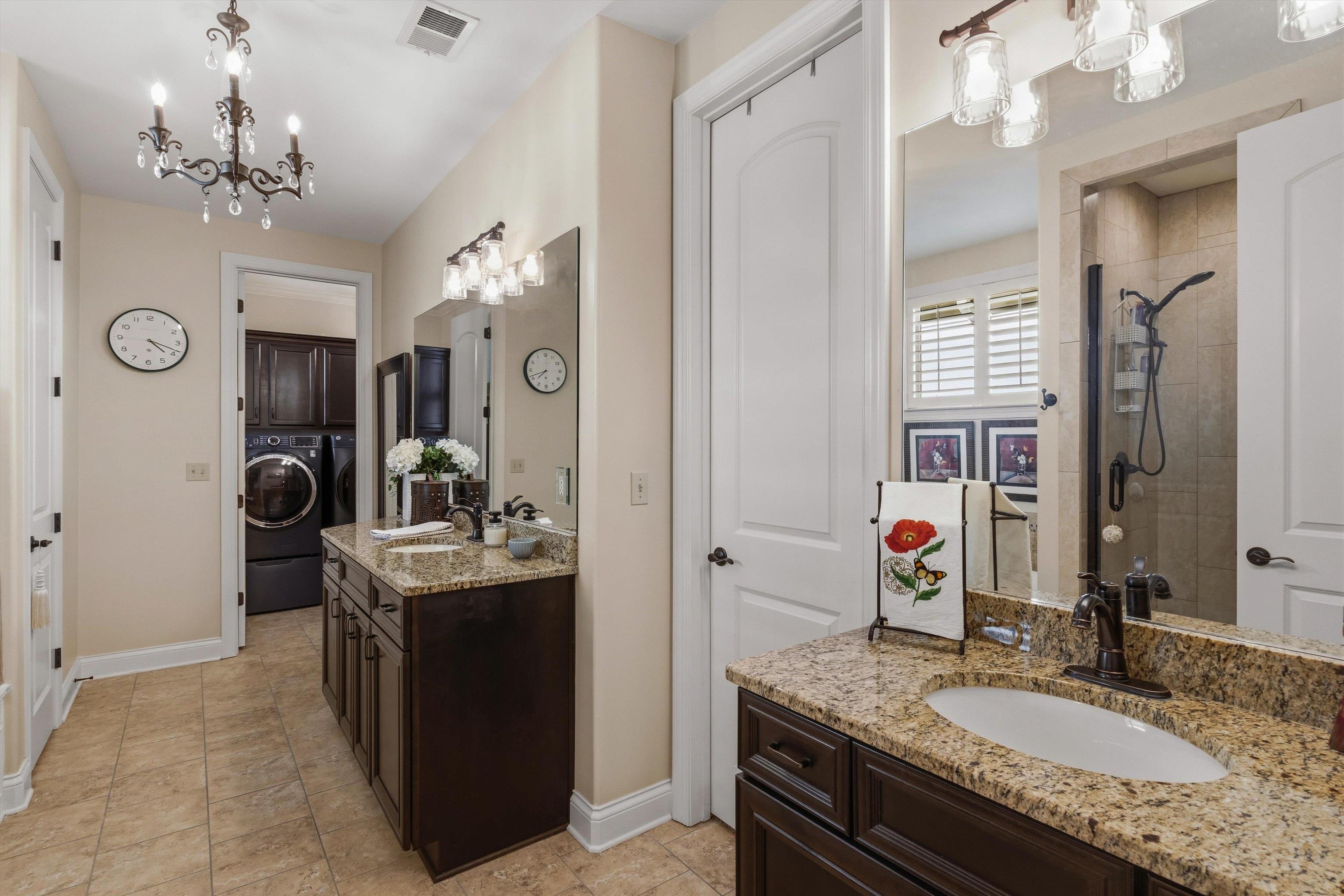 1011 Ostlers Way Collierville, TN 38017 - Photo 17 of 31 a bathroom with a granite countertop sink a large mirror and a shower
