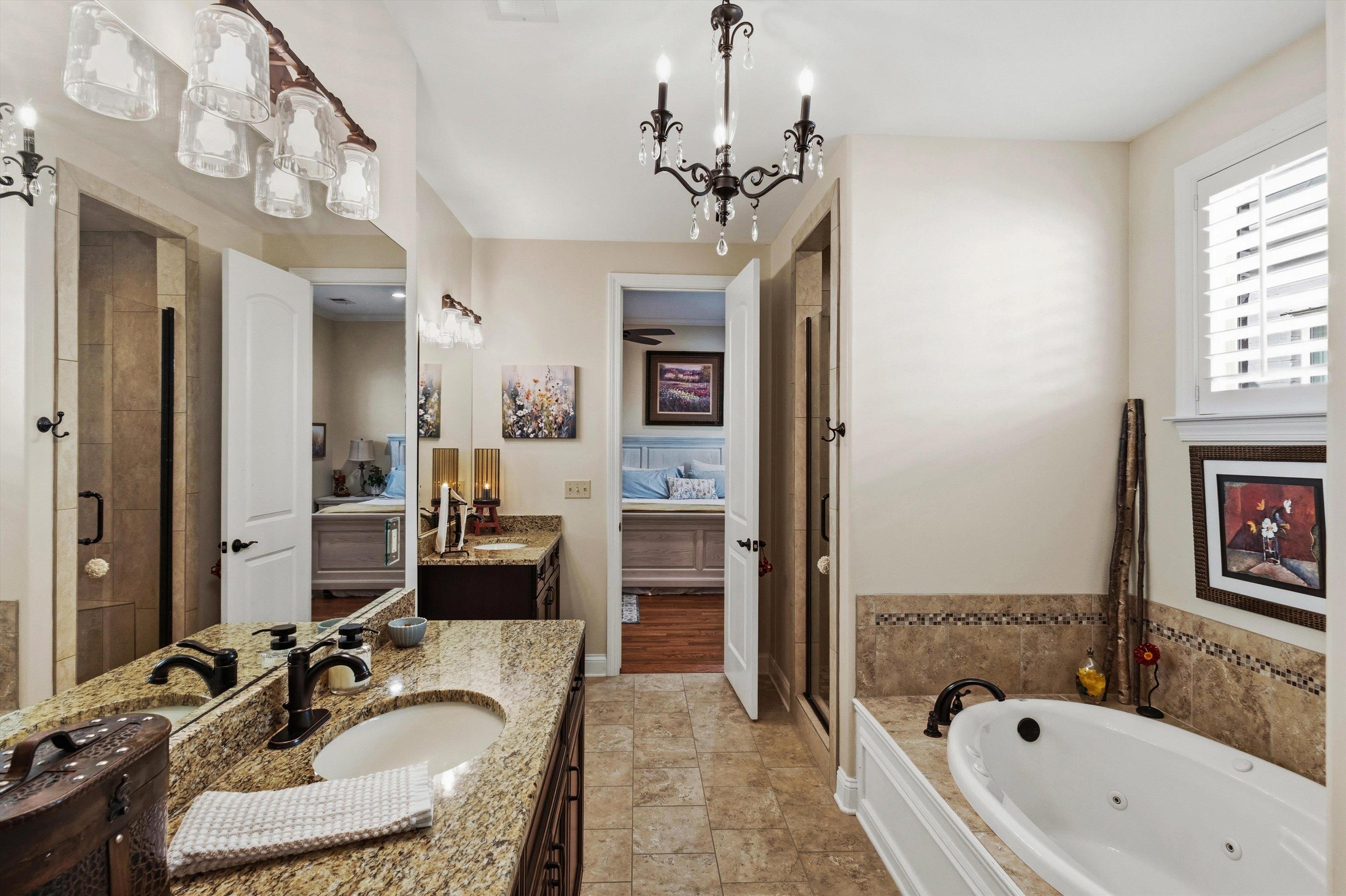1011 Ostlers Way Collierville, TN 38017 - Photo 18 of 31 a en suite spacious bathroom with a granite countertop tub sink and mirror