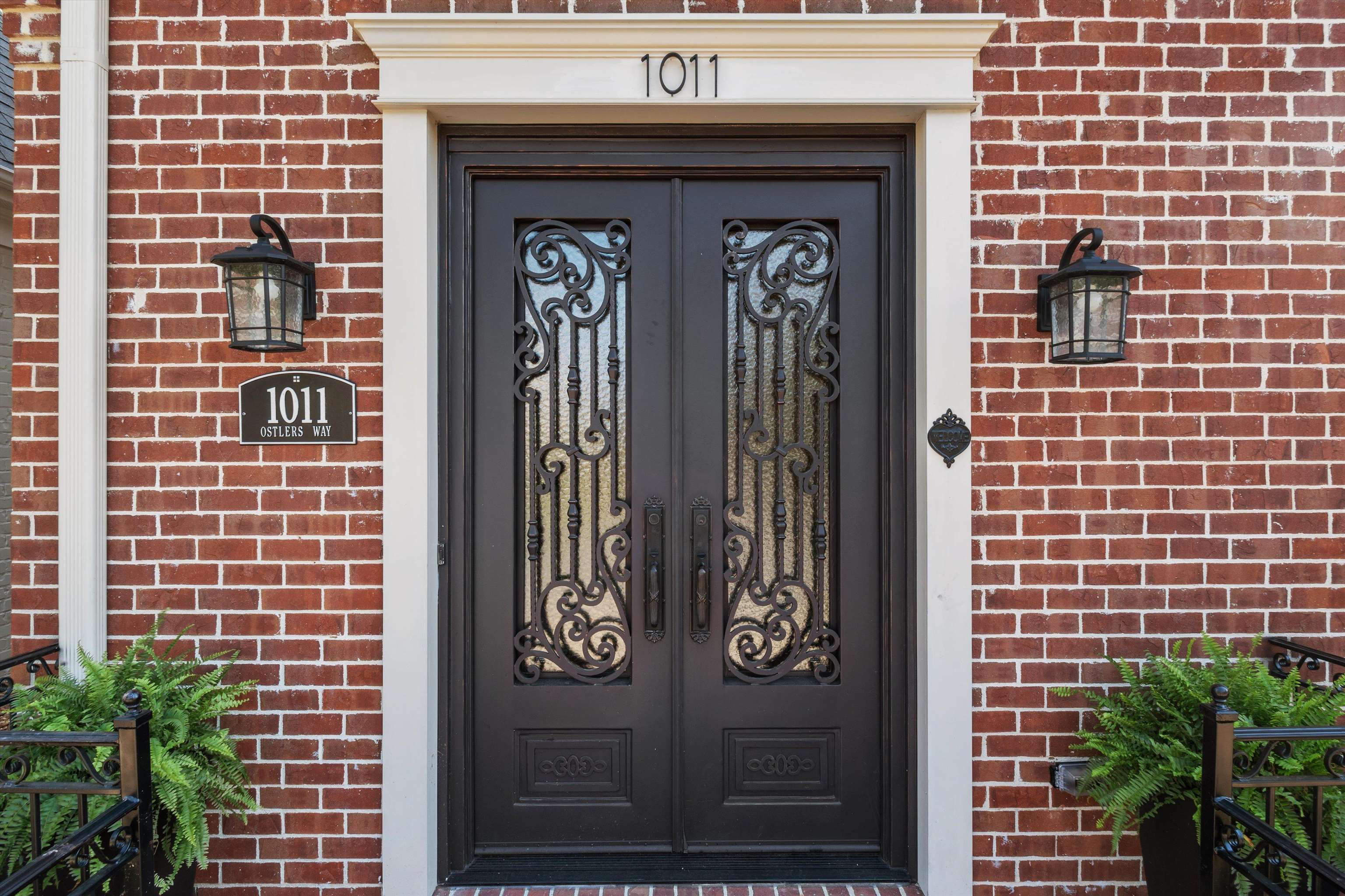 1011 Ostlers Way Collierville, TN 38017 - Photo 2 of 31 a front view of a building with a door and a shower