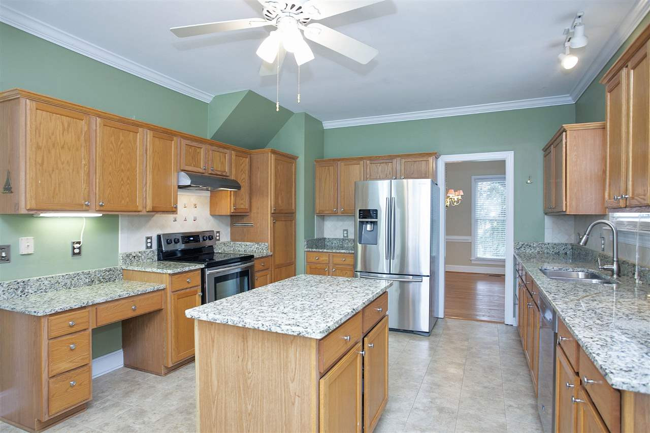 5216 Covington Bend Drive Raleigh, NC 27613 - Photo 5 of 15 Another view of the kitchen demonstrates how roomy it is, perfect for having helpers while you prepare a meal. Kitchen