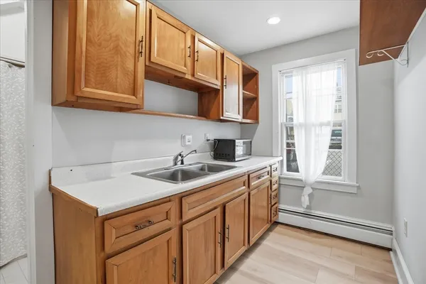 a kitchen with stainless steel appliances granite countertop a sink and dishwasher next to a window