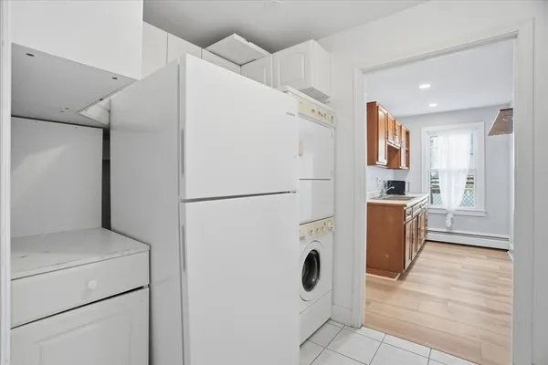 a kitchen with a refrigerator a stove top oven and cabinets