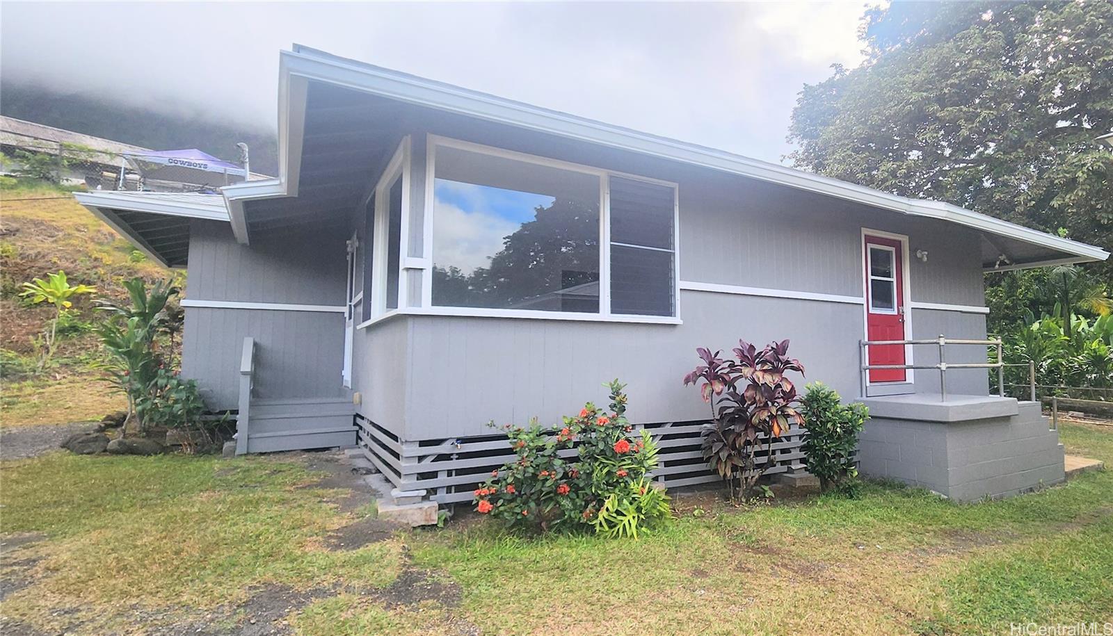 41-978B Waikupanaha Street, Unit B4 Waimanalo, HI 96795 - Photo 1 of 18 a backyard of a house with table and chairs