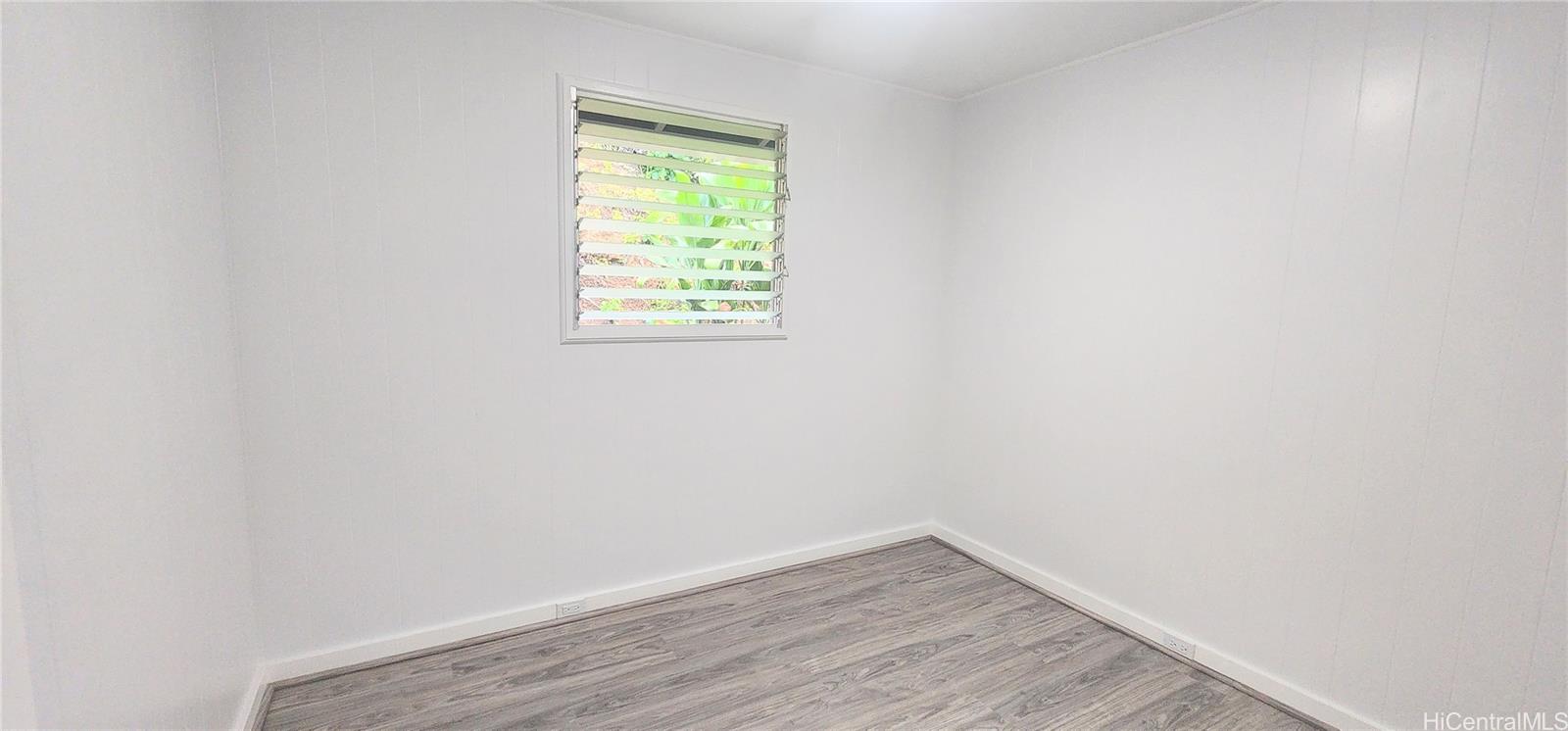 41-978B Waikupanaha Street, Unit B4 Waimanalo, HI 96795 - Photo 12 of 18 a view of an empty room with wooden floor and a window