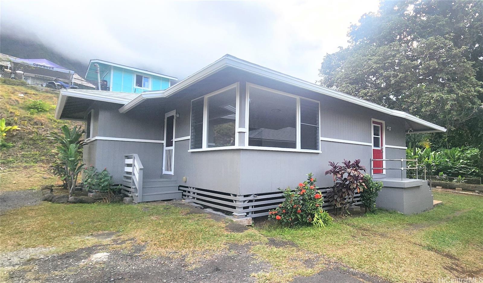 41-978B Waikupanaha Street, Unit B4 Waimanalo, HI 96795 - Photo 17 of 18 a view of a house with wooden walls and a yard