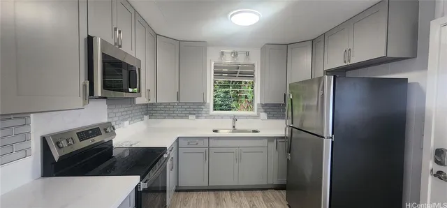 a kitchen with a sink stove and refrigerator