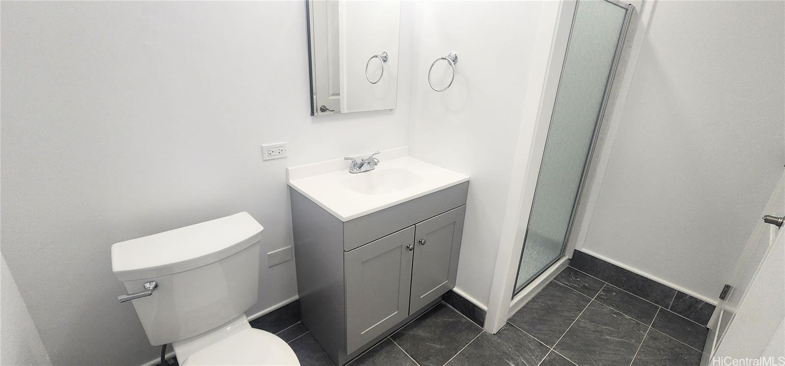 41-978B Waikupanaha Street, Unit B4 Waimanalo, HI 96795 - Photo 7 of 18 a white toilet sitting next to a bathroom sink