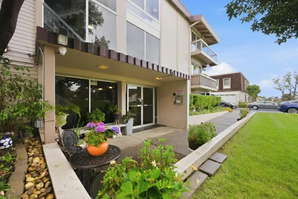 a view of a building with garden and sitting area