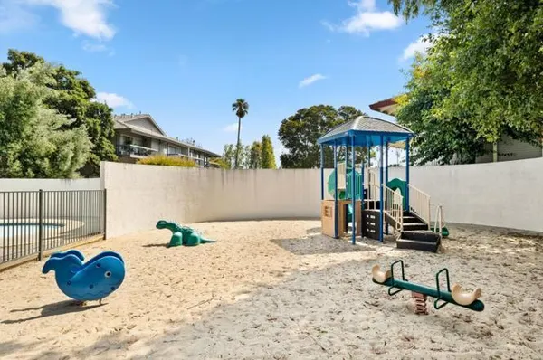 a view of a backyard with chairs and a tree