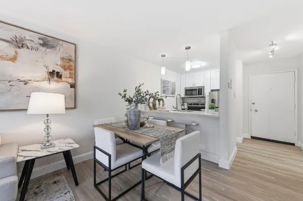 a dining room with furniture and wooden floor