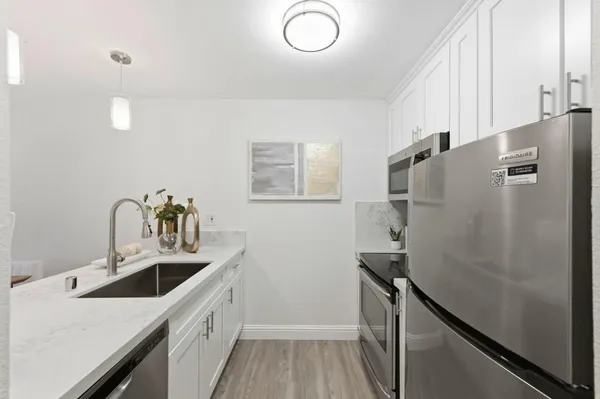 a kitchen with a refrigerator and a sink