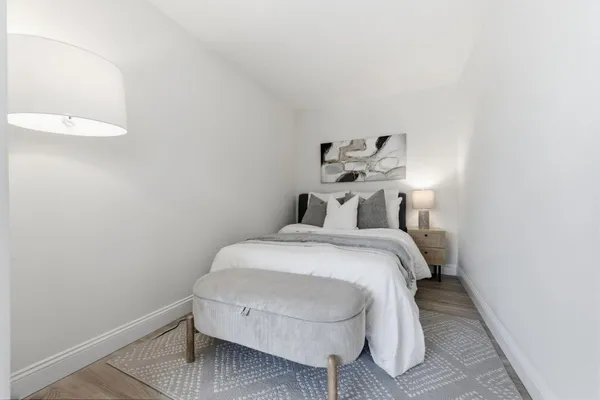 a bedroom with a bed and a table