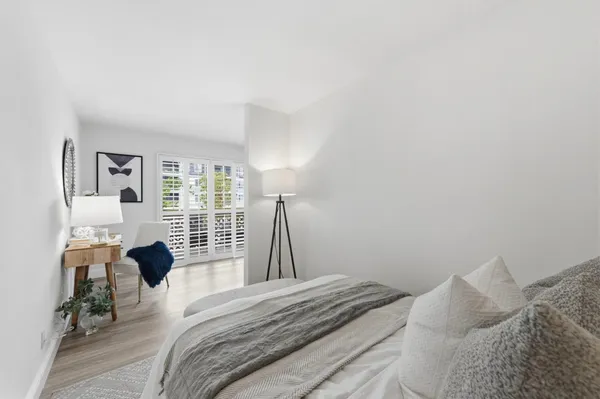 a bedroom with a bed and a large window