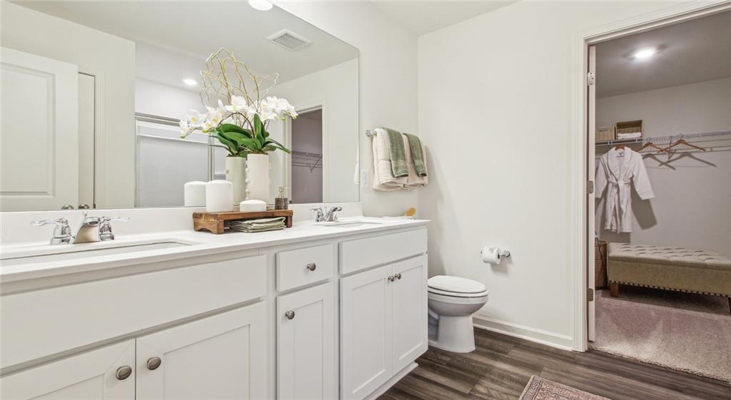3373 Fence Road Northeast, Unit D4 Dacula, GA 30019 - Photo 29 of 40 a bathroom with a sink a toilet and a mirror