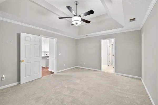 a view of an empty room and kitchen view