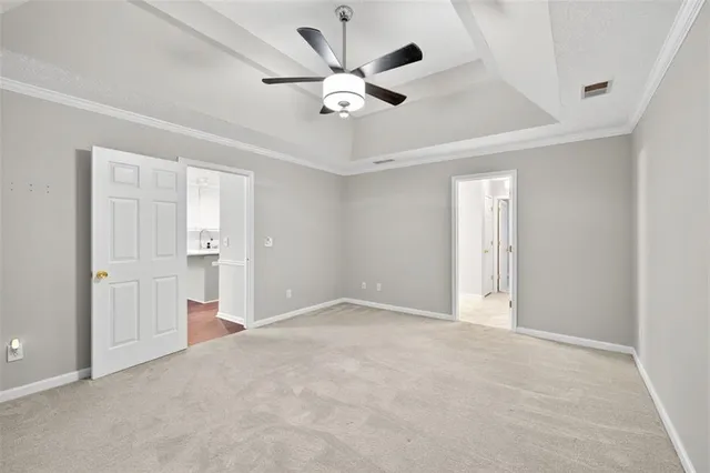 a view of an empty room and kitchen view