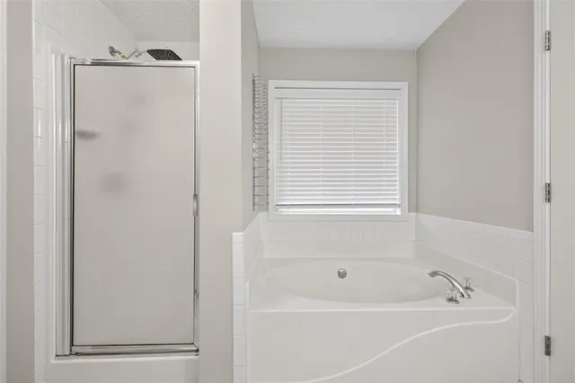 a white bath tub sitting next to a window