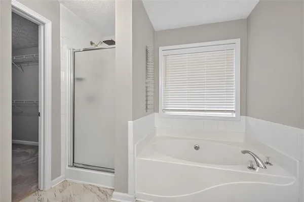 a white bath tub sitting next to a window