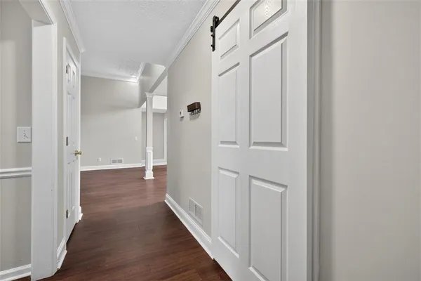 a view of a hallway with wooden floor