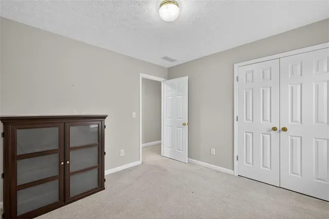 a view of an empty room and closet area