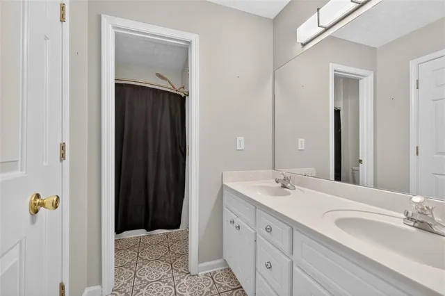a bathroom with a double vanity sink and mirror
