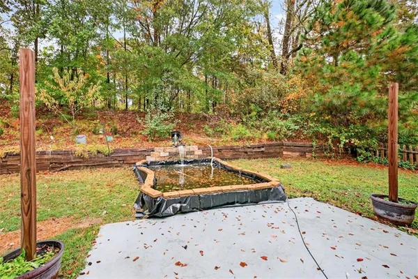a view of a house with backyard and sitting area