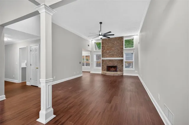 wooden floor in an empty room with a window