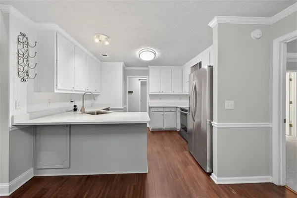 a kitchen with a sink stainless steel appliances and cabinets