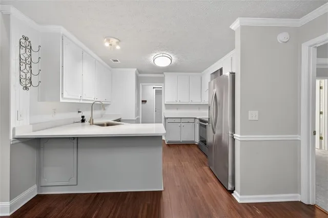a kitchen with a sink stainless steel appliances and cabinets
