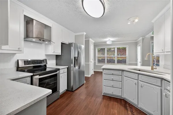a kitchen with stainless steel appliances a refrigerator sink and cabinets