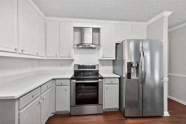 a kitchen with cabinets and stainless steel appliances