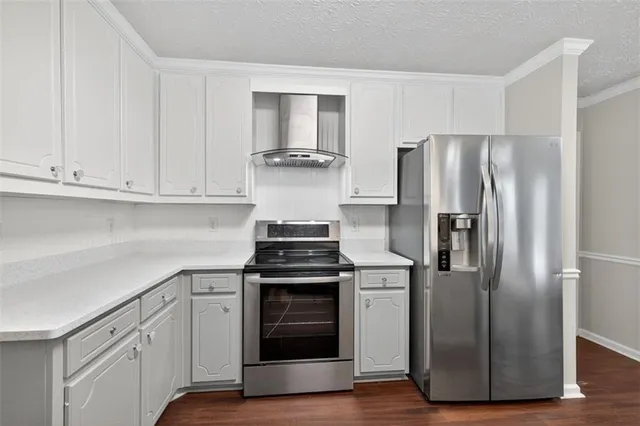 a kitchen with cabinets and stainless steel appliances