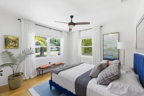 a bedroom with a bed and a chandelier